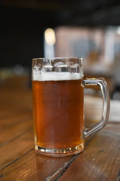 Glass of beer on wooden table. Beer in a glass