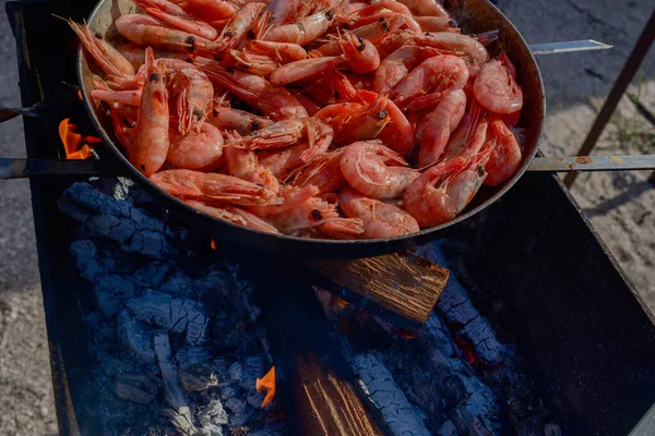 shrimp. Shrimps are cooked in a pan over a fire. Bonfire seafood