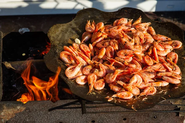 shrimp. Shrimps are cooked in a pan over a fire. Bonfire seafood. Food photography