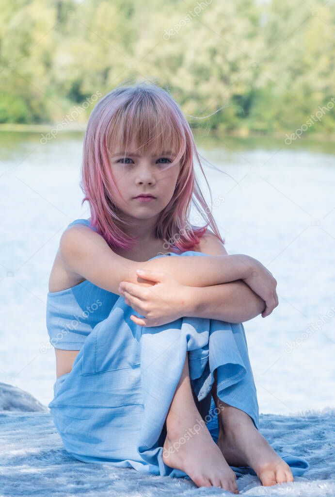 cute child girl portrait . Outdoor portrait of cute little girl in summer day. Portrait of a little girl with pink hair. Child 7-8 years old. Teenager