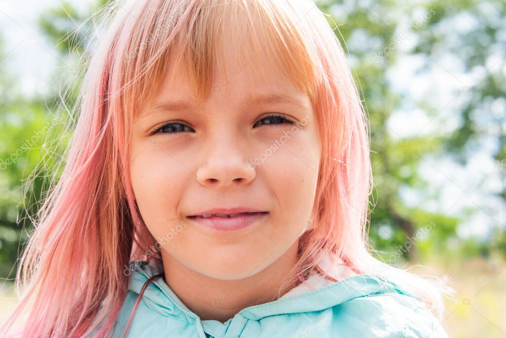cute child girl portrait . Outdoor portrait of cute little girl in summer day. Portrait of a little girl with pink hair. Child 6-7 years old