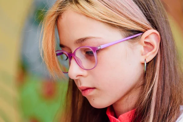 Girl schoolgirl close-up portrait in glasses at school. Close up portrait of beautiful, pretty, charming, lovely blonde girl. School concept. Knowledge, school, teenager