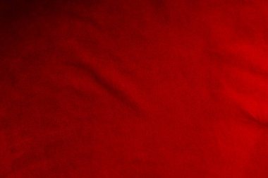 Süet kumaştan koyu kırmızı bir arka plan, yakın plan. Dikensiz şarap derisinin kadife dokusu. Keçeleşmiş makro. Kırmızı doku