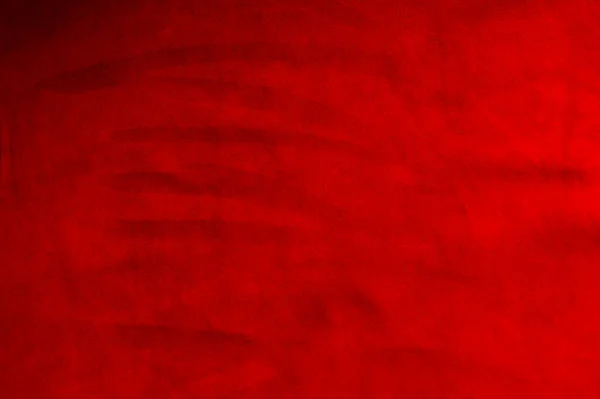 Dark red matte background of suede fabric, closeup. Velvet texture of seamless wine leather. Felt material macro. Red texture