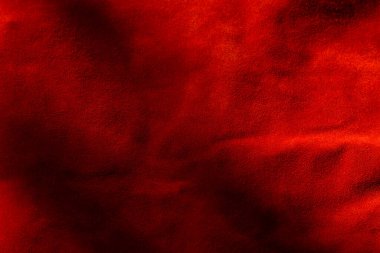 Süet kumaştan koyu kırmızı bir arka plan, yakın plan. Dikensiz şarap derisinin kadife dokusu. Keçeleşmiş makro. Kırmızı doku