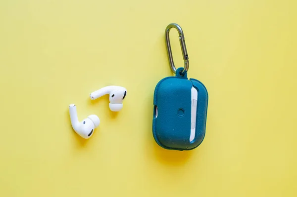 wireless headphones. Wireless Bluetooth Earphone or Earbud or Headphone, Isolated on yellow background