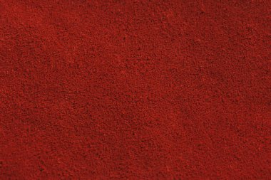 Red matte background of suede fabric, closeup. Velvet texture of seamless leather. Felt material macro. Red suede texture. Fabric, leather, material for designers. clipart