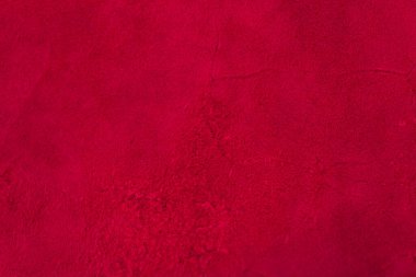 Süet kumaşın kırmızı mat arka planı, yakın plan. Pürüzsüz deri kadife desenli. Keçeleşmiş makro. Kırmızı süet kumaş. Kumaş, deri, tasarımcılar için malzeme..