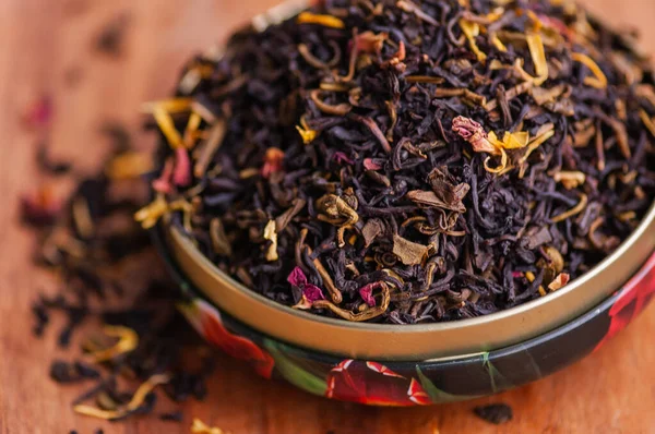 Green tea with a rose. Flavored black, dried tea mix with rose petals. a mixture of black and green tea with the addition of cornflower and tea rose petals. dry tea leaves