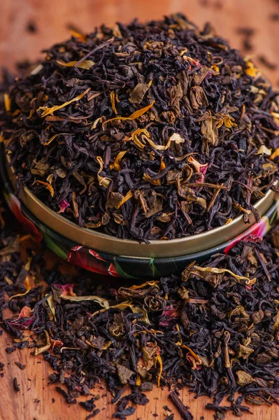 Green tea with a rose. Flavored black, dried tea mix with rose petals. a mixture of black and green tea with the addition of cornflower and tea rose petals. dry tea leaves