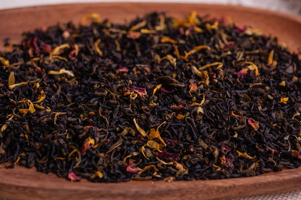 Green tea with a rose. Flavored black, dried tea mix with rose petals. a mixture of black and green tea with the addition of cornflower and tea rose petals. dry tea leaves