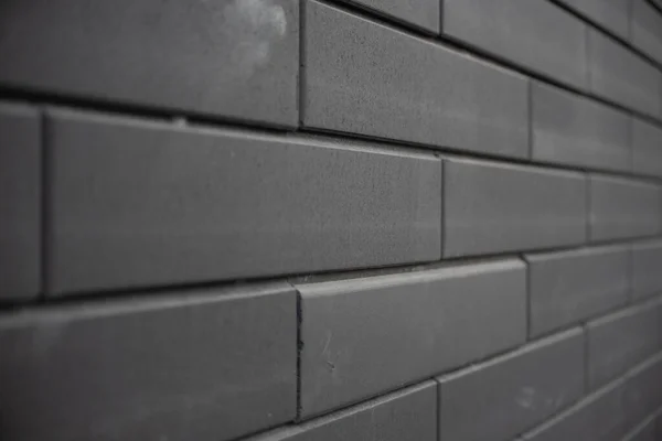 Black brick wall. Urban black brick wall texture masonry background.