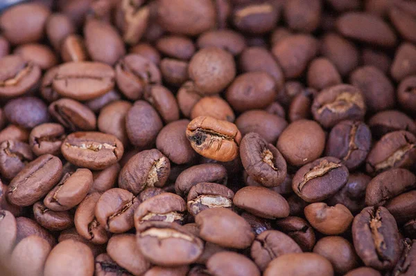 Coffee beans background. Light roasted natural coffee beans. Morning and vigor, caffeine. Arabica