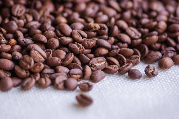 Coffee beans background. Light roasted natural coffee beans. Morning and vigor, caffeine. Arabica