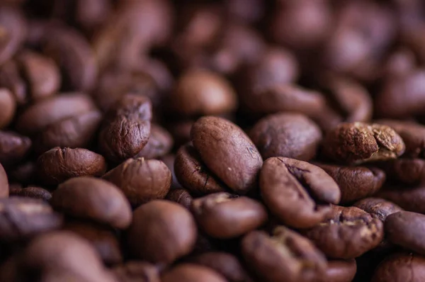 Coffee beans background. Light roasted natural coffee beans. Morning and vigor, caffeine. Arabica