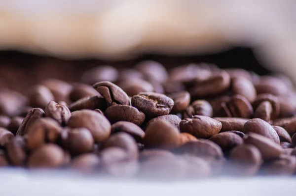 Coffee beans background. Light roasted natural coffee beans. Morning and vigor, caffeine. Arabica