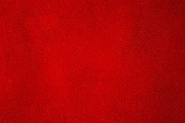 Kırmızı, mükemmel süet kumaştan bir arka plan. Kadife kumaş. Doğal kırmızı süetin dokusu.