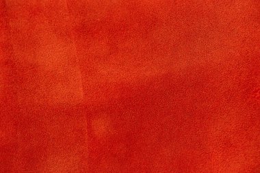 Arka plan makro fotoğrafı olarak kırmızı süet deri.