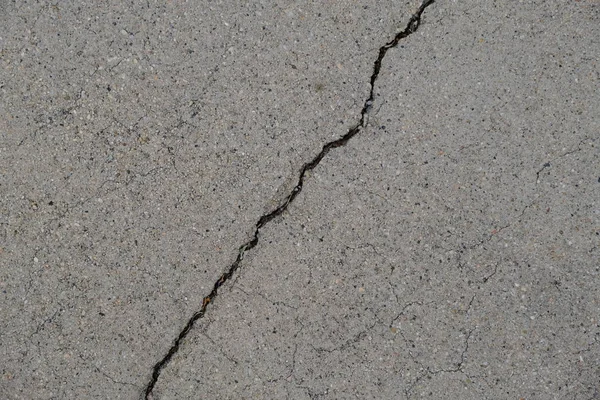 Crack in concrete on the streets of Los Angeles. Background for interior design.