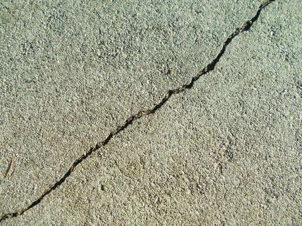 Crack in concrete on the streets of Los Angeles. Background for interior design.