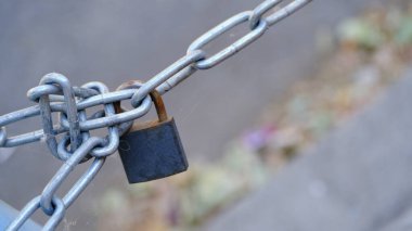 Bulanık zeminde paslı metal bir zincir.