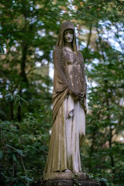 Stone statue of a mourning woman as decoration on a graveyard