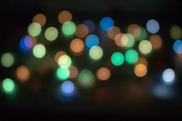 abstract background of colored lights. defocused. Colorful light bulbs and bright round lanterns, bokeh, festive mood.