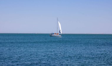 Açık güneşli bir günde denizde yelken açmak. Seyahat ve aktif yaşam tarzı kavramı.