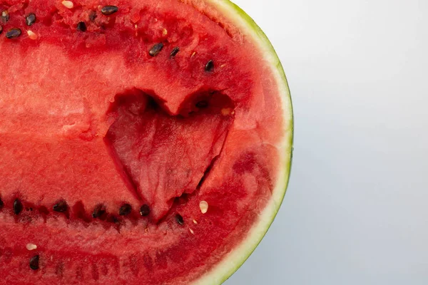 The heart is carved in a fresh watermelon on a white background.Place for your text.