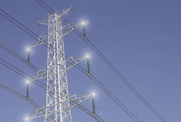 Low angle view of electric power transmission lines against blue sky