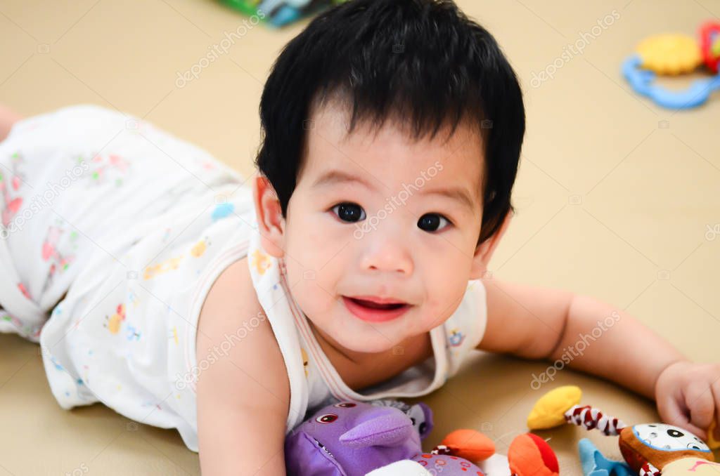 baby on bed with toy,kid smile