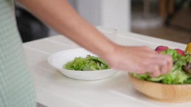 Evde mutfakta sağlıklı bir kahvaltı pişirme salata, sebze, çilek yapmak için Asyalı kadın malzemeler kapatın.