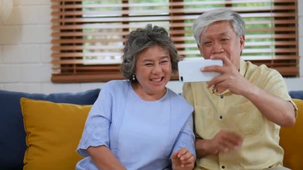 Asian Senior Couple Having Video Chat Using Smartphone Sharing Social — Stock Video