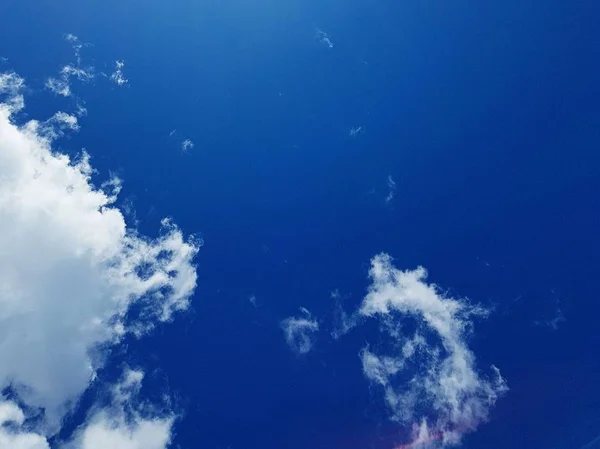 White clouds in a blue sky on a sunny day in summer