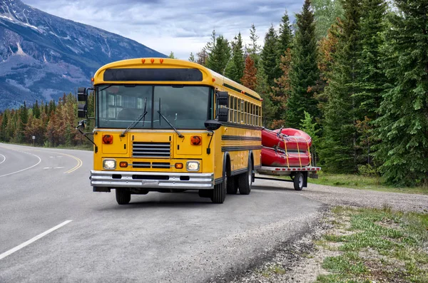 yellow bus carries two red boats on the background of a pine forest ��� ������������ 3