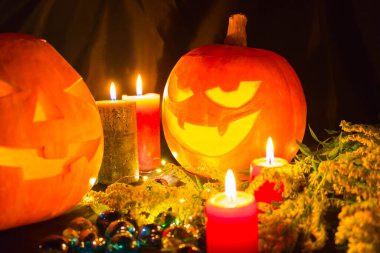 Siyah arka planda mumları olan Cadılar Bayramı balkabakları