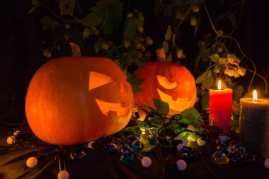 Siyah arka planda mumları olan Cadılar Bayramı balkabakları