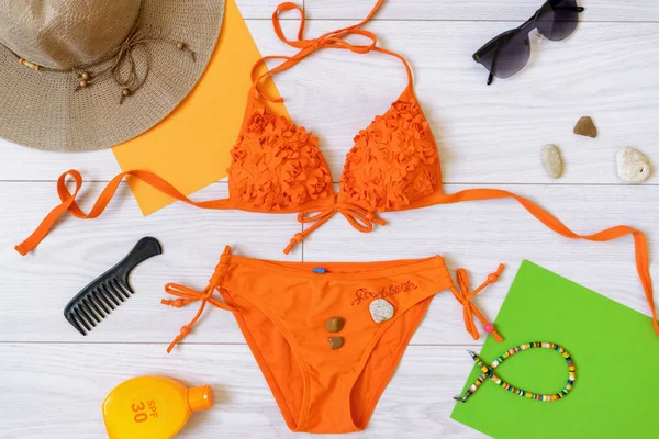 modern summer flat lay with swimsuit and accessories