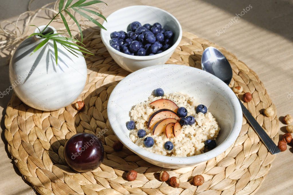 Oatmeal with berries, nuts, plums and chia seeds.