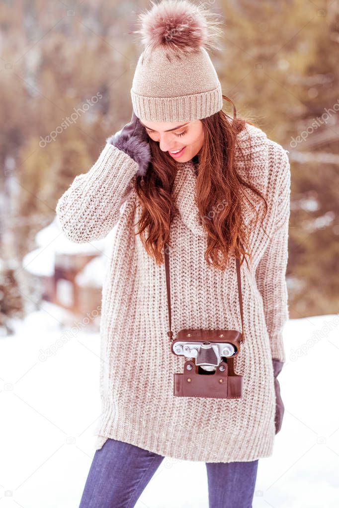 Beautiful girl taking a picture in the mountains. 