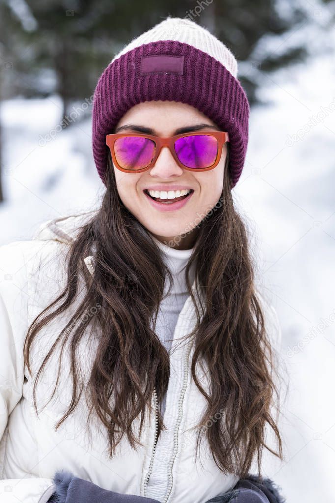 Beautiful woman is playing with snow.