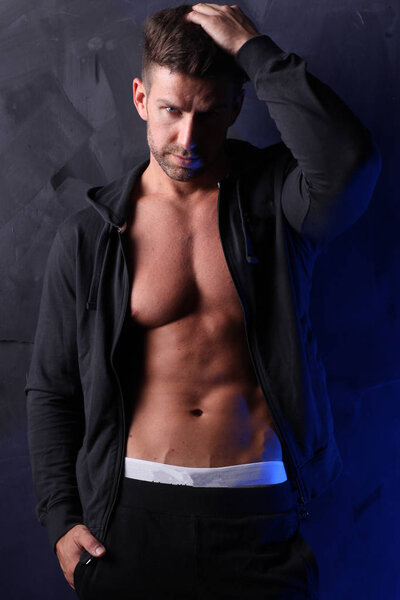 Sexy man posing in underwear and blouse.