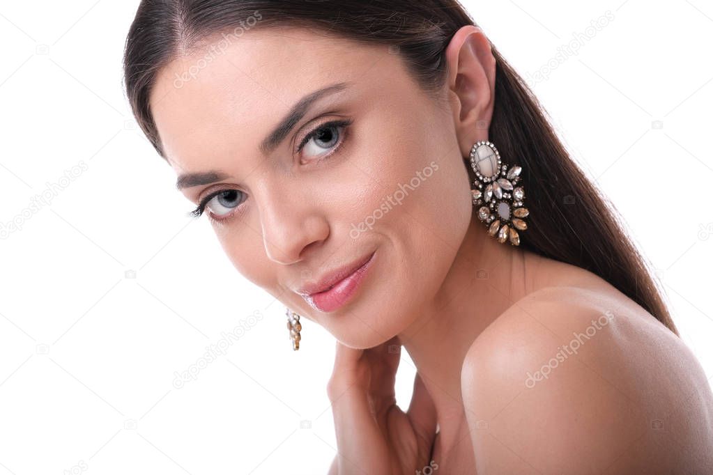 Young, elegant woman with glamour make up and rich earrings.