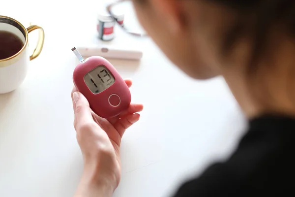 Woman sick on diabetes, is checking her glucose level.