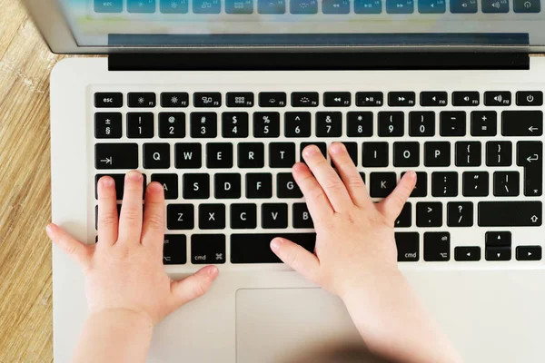 Kids hands on keyboard. Little hacker.