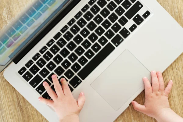 Kids hands on keyboard. Little hacker.