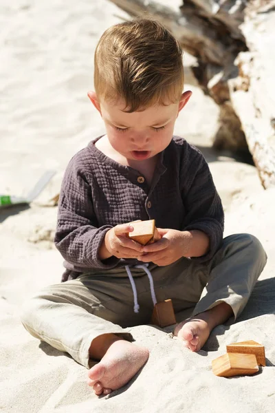 Zainteresowany Dziecko Próbuje Umieścić Bloki Razem Plaży — Zdjęcie stockowe