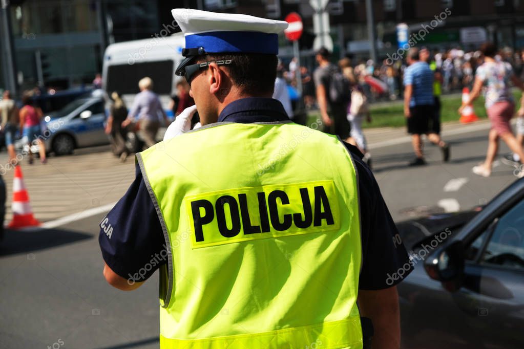 Katowice, Poland-august/15/2019 The policeman on the street on duty. Close up of police logo.