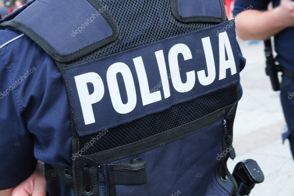 Katowice, Poland-august/15/2019 The policeman on the street on duty. Close up of police logo.