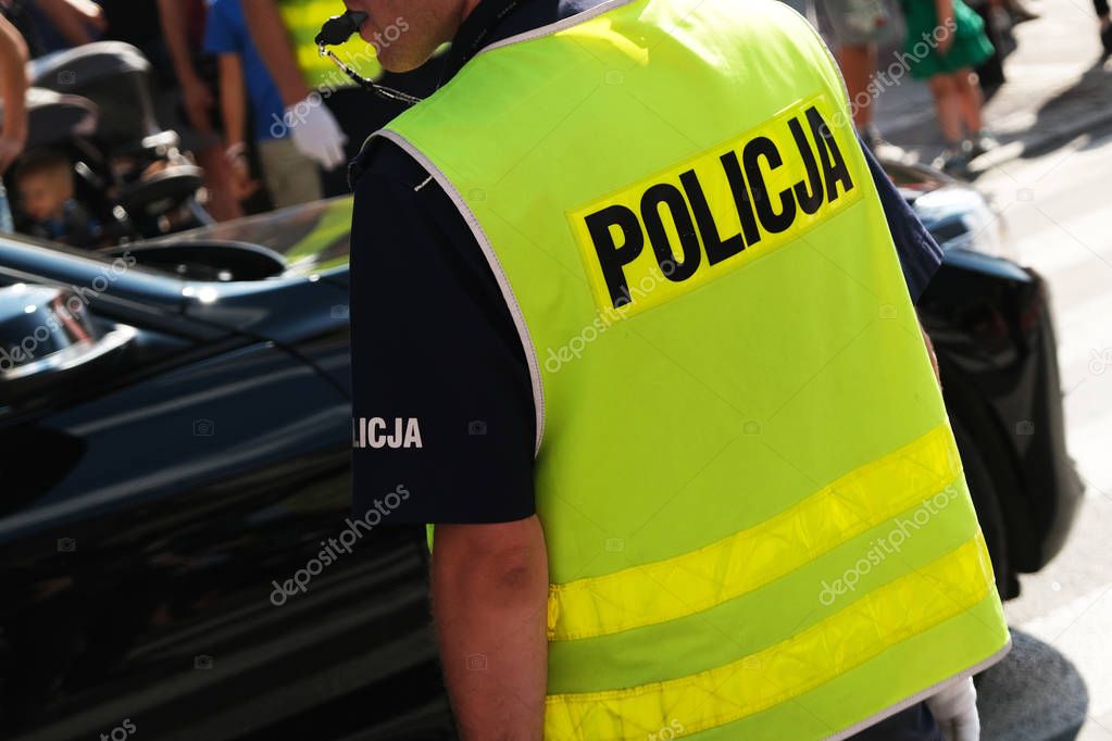 Katowice, Poland-august/15/2019 The policeman on the street on duty. Close up of police logo.